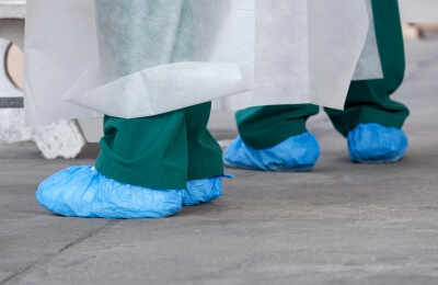 Two doctors wearing shoe covers